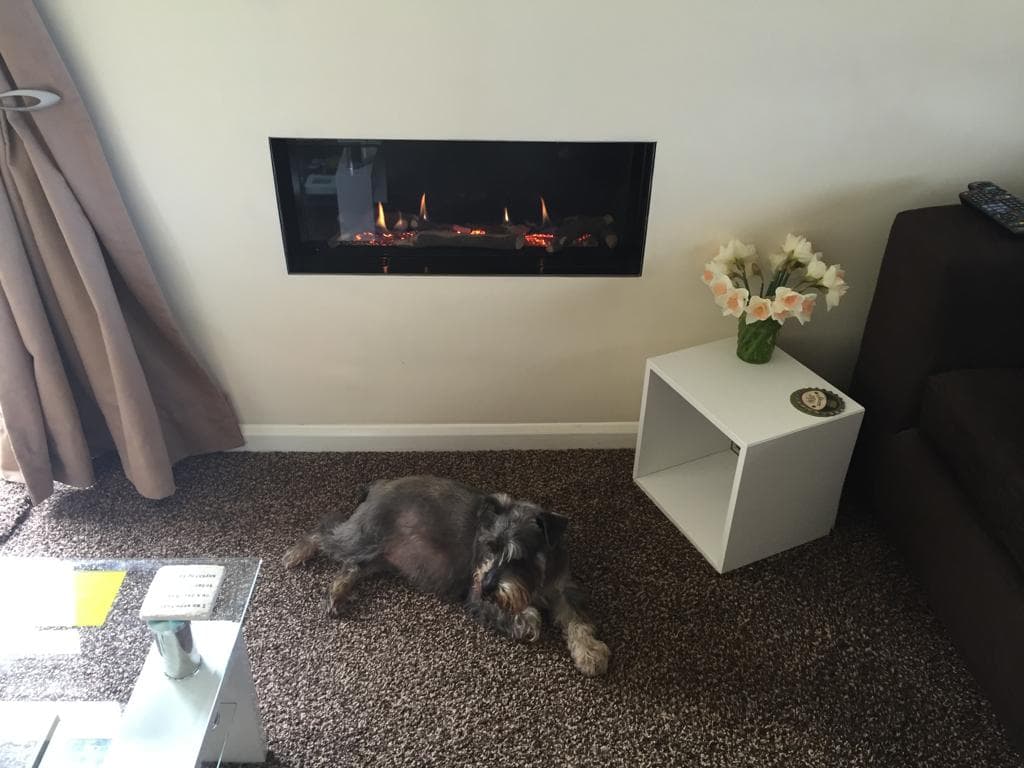 Wall-mounted inset gas fire in a living room
