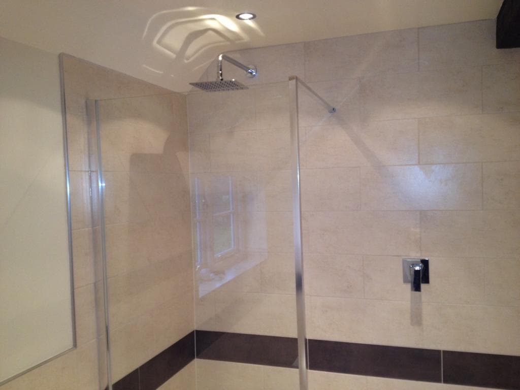 Walk-in shower enclosure with ceiling rainfall shower head